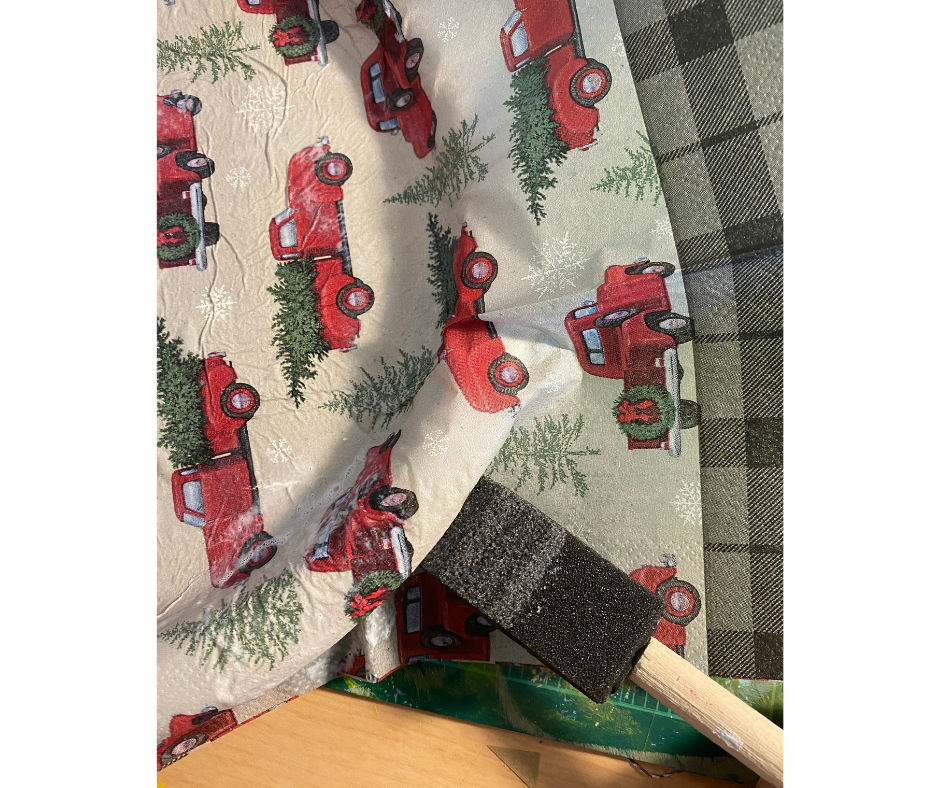 brush applying mod podge to paper napkin on plate